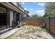 Small backyard features a concrete patio, chairs and partial privacy fence at 874 Commonwealth Ct, Casselberry, FL 32707