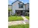Inviting two-story townhome with well-manicured lawn and charming brick accents at 874 Commonwealth Ct, Casselberry, FL 32707