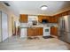 Modern kitchen featuring wooden cabinetry, and stainless steel appliances at 874 Commonwealth Ct, Casselberry, FL 32707