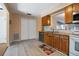 Cozy kitchen features wood cabinets, granite countertops, and tile flooring at 874 Commonwealth Ct, Casselberry, FL 32707