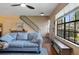 Bright living room with hardwood floors, a large window, and a comfortable seating area at 874 Commonwealth Ct, Casselberry, FL 32707