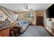 Bright living area with a comfortable sofa, ceiling fan, and a large window at 874 Commonwealth Ct, Casselberry, FL 32707