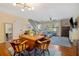 Open-concept living room features hardwood floors, stairs, and natural light at 874 Commonwealth Ct, Casselberry, FL 32707