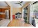 Open living space with backyard access, modern fixtures, and adjacent kitchen area at 874 Commonwealth Ct, Casselberry, FL 32707