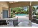 Relaxing poolside view from a shaded patio with tables and chairs at 874 Commonwealth Ct, Casselberry, FL 32707