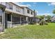 Backyard featuring green grass, and views of the screened in patios at 903 Deer Springs Rd, Port Orange, FL 32129