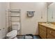 Small bathroom featuring a standard toilet, storage shelving, and a wooden vanity at 903 Deer Springs Rd, Port Orange, FL 32129