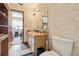 Bathroom with a wooden cabinet and laminate countertop paired with a decorated mirror at 903 Deer Springs Rd, Port Orange, FL 32129