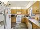 Functional kitchen with white appliances, ample wood cabinetry, and a well-lit, inviting atmosphere at 903 Deer Springs Rd, Port Orange, FL 32129