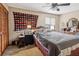 Comfortable bedroom with ceiling fan, closet, and natural light from the window at 903 Deer Springs Rd, Port Orange, FL 32129