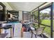 Covered patio filled with boxes, shelving, a grill, and a white cushioned chair at 903 Deer Springs Rd, Port Orange, FL 32129
