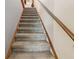 Carpeted staircase with a wooden handrail, leading to the next level of the home at 903 Deer Springs Rd, Port Orange, FL 32129