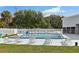 Community swimming pool with sun loungers and tables behind a secure white fence at 903 Deer Springs Rd, Port Orange, FL 32129