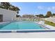 Community swimming pool with stairs, and secure access behind white fence at 903 Deer Springs Rd, Port Orange, FL 32129