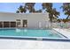Community swimming pool with steps, and secure access behind white fence at 903 Deer Springs Rd, Port Orange, FL 32129