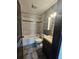 Updated bathroom with tiled shower, modern vanity, and storage shelves at 922 Saxon Blvd, Deltona, FL 32725