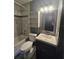 Stylish bathroom featuring a tiled tub, a sink with a mirror and a shelf at 922 Saxon Blvd, Deltona, FL 32725