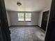 Relaxing bedroom featuring tile floors, two windows and neutral walls at 922 Saxon Blvd, Deltona, FL 32725