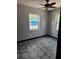Cozy bedroom with two windows, tile floor and ceiling fan at 922 Saxon Blvd, Deltona, FL 32725