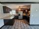 Functional kitchen with stainless steel appliances, dark wood cabinets and breakfast bar at 922 Saxon Blvd, Deltona, FL 32725