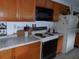 Functional kitchen with wood cabinets, and essential appliances, perfect for home-cooked meals at 942 Lemon Bluff Rd, Osteen, FL 32764