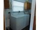 Convenient laundry room with washer, dryer, and storage cabinets, making laundry tasks easy at 942 Lemon Bluff Rd, Osteen, FL 32764