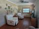 Cozy living room with wood paneling, two recliners, and a ceiling fan at 942 Lemon Bluff Rd, Osteen, FL 32764