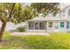 The backyard features a screened patio, and a lush green lawn, perfect for outdoor activities and enjoyment at 961 S Lakewood Ter # C, Port Orange, FL 32127