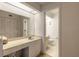 Bathroom with a vanity, mirror, and toilet; the shower is in a separate room at 961 S Lakewood Ter # C, Port Orange, FL 32127