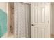 Shower featuring a bathtub and white patterned shower curtain, next to a white door at 961 S Lakewood Ter # C, Port Orange, FL 32127