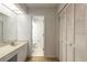 Bright bathroom features a single vanity, toilet and linen closet for storage at 961 S Lakewood Ter # C, Port Orange, FL 32127