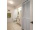 Bathroom with white cabinets, tile floors, and bright lighting at 961 S Lakewood Ter # C, Port Orange, FL 32127