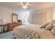 A bedroom with natural lighting, ceiling fan, large mirror and a bed at 961 S Lakewood Ter # C, Port Orange, FL 32127