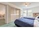 This is a bright bedroom featuring two twin beds, a ceiling fan, and natural light from the window at 961 S Lakewood Ter # C, Port Orange, FL 32127