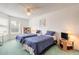 This cozy bedroom features two twin beds with blue comforters and a ceiling fan at 961 S Lakewood Ter # C, Port Orange, FL 32127
