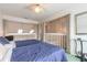 Bright bedroom featuring two twin beds overlooking a second-story railing at 961 S Lakewood Ter # C, Port Orange, FL 32127