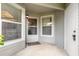 Well-lit entryway features a covered porch, door, and window at 961 S Lakewood Ter # C, Port Orange, FL 32127