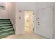 Bright foyer with stairs, tile flooring, and view of a bathroom at 961 S Lakewood Ter # C, Port Orange, FL 32127