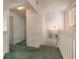 A well lit hallway with a view of stairs and a painting at 961 S Lakewood Ter # C, Port Orange, FL 32127