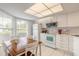 Open kitchen with white cabinetry, tile flooring, and eat-in dining at 961 S Lakewood Ter # C, Port Orange, FL 32127