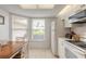 Eat-in kitchen features white cabinetry, appliances, and bright natural light at 961 S Lakewood Ter # C, Port Orange, FL 32127