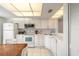Bright kitchen with white cabinets, appliances, and tile floors at 961 S Lakewood Ter # C, Port Orange, FL 32127