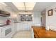 Bright kitchen with white appliances and cabinetry, and tiled flooring at 961 S Lakewood Ter # C, Port Orange, FL 32127