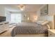 Bright main bedroom with neutral tones, ceiling fan, and access to an enclosed lanai at 961 S Lakewood Ter # C, Port Orange, FL 32127