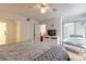 Cozy bedroom features access to the enclosed lanai, ceiling fan and ensuite bath access at 961 S Lakewood Ter # C, Port Orange, FL 32127