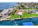 Stunning aerial view of waterfront homes with docks and canal access near the open bay and skyline at 10 Venetian Cir, Port Orange, FL 32127