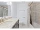 Bathroom boasts a tile backsplash, dark vanity, granite countertop, and shower with curtain at 10 Venetian Cir, Port Orange, FL 32127