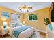 Comfortable bedroom with a ceiling fan, two windows and bright blue décor accents at 10 Venetian Cir, Port Orange, FL 32127