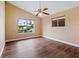 Bedroom featuring hard wood floors, a ceiling fan, and natural light at 10 Venetian Cir, Port Orange, FL 32127