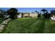 Charming home exterior with well-maintained lawn, rock accents, storage shed, and bright, enclosed porch at 10 Venetian Cir, Port Orange, FL 32127